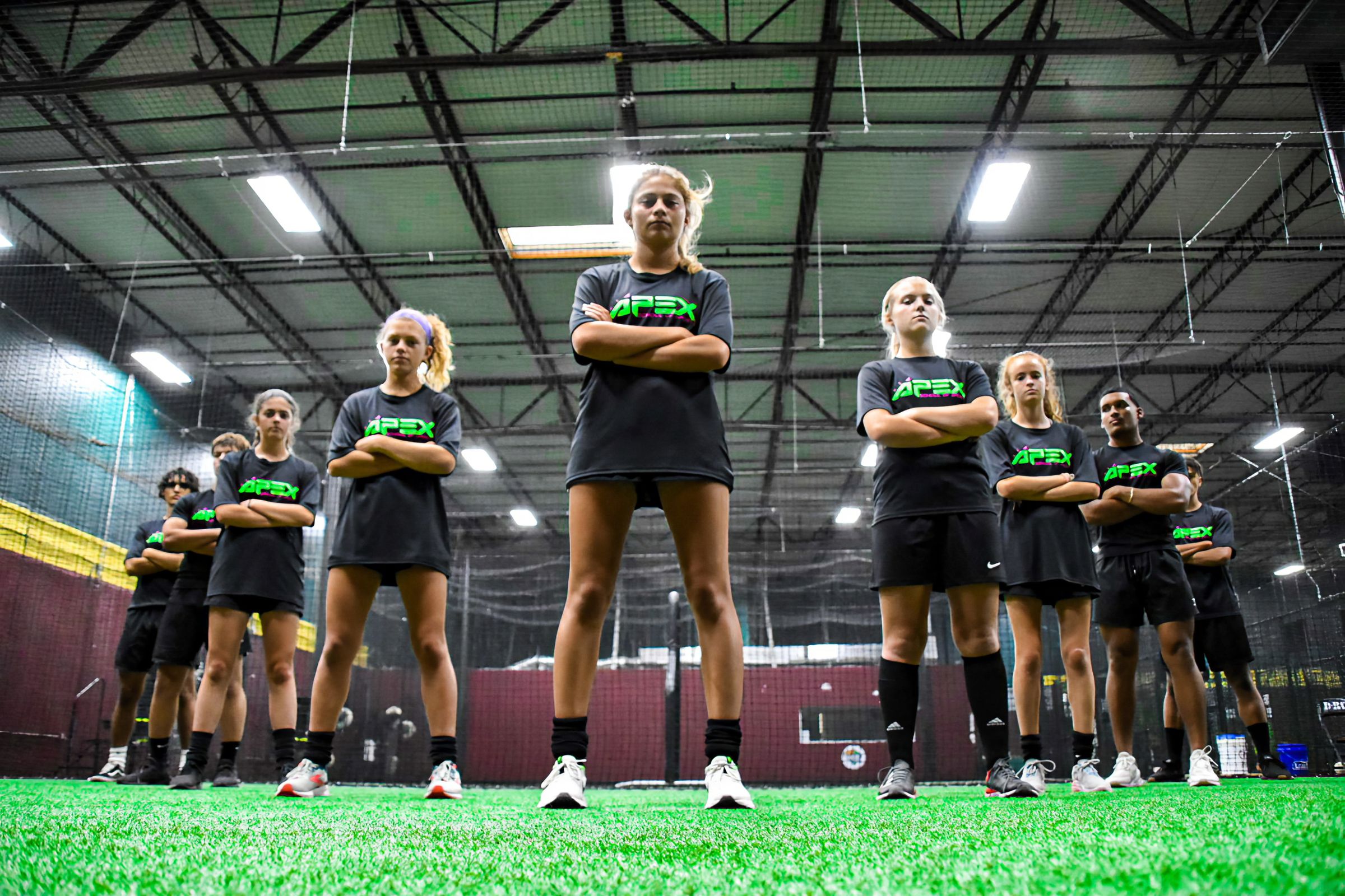 APEX athletes lined up on the turf